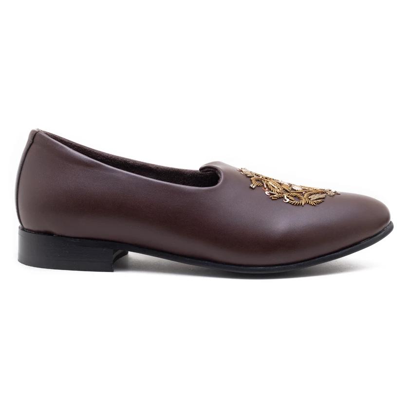 A pair of Monkstory Magenta Mojri shoes with brown embroidered designs.