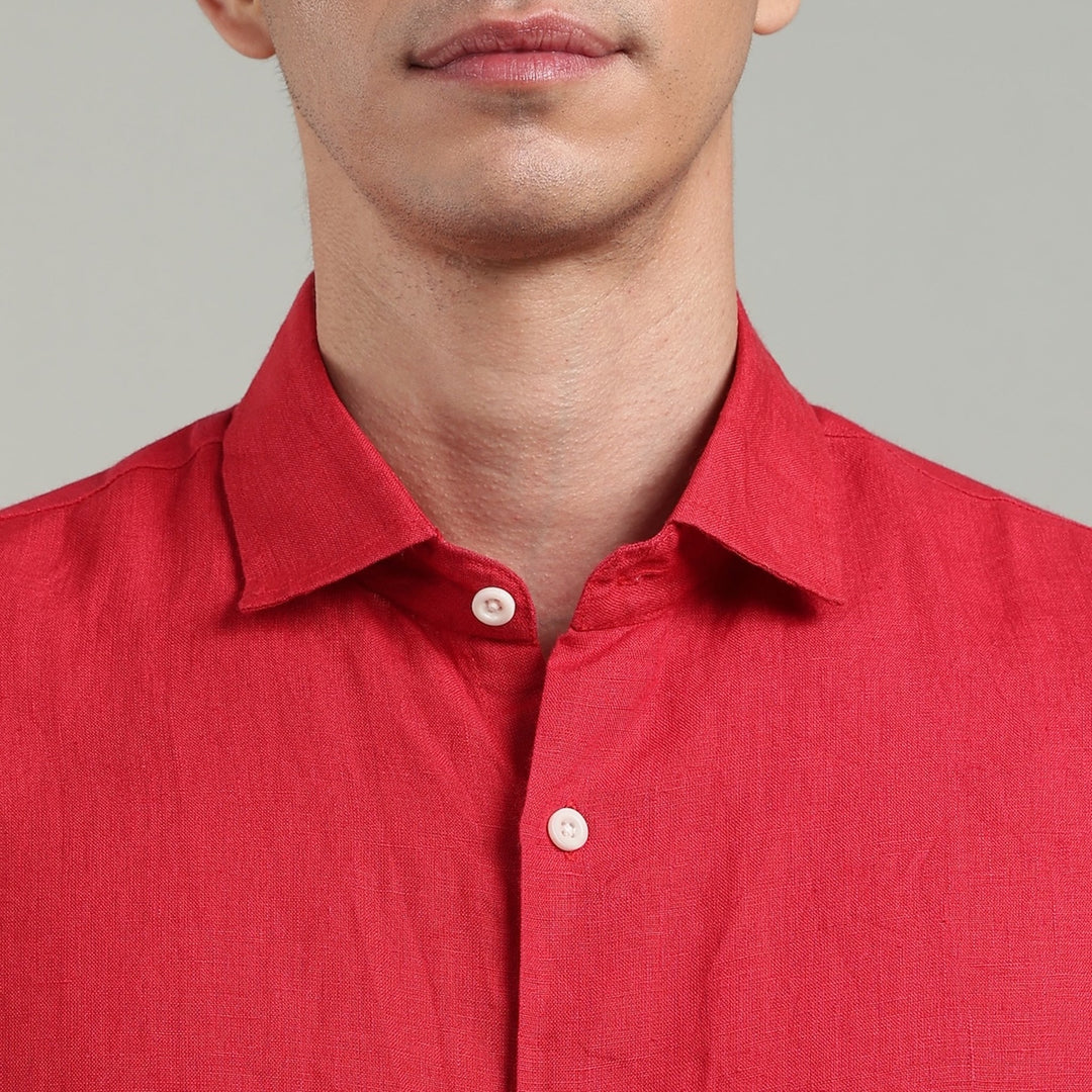 Red linen shirt worn by a person on a gray background