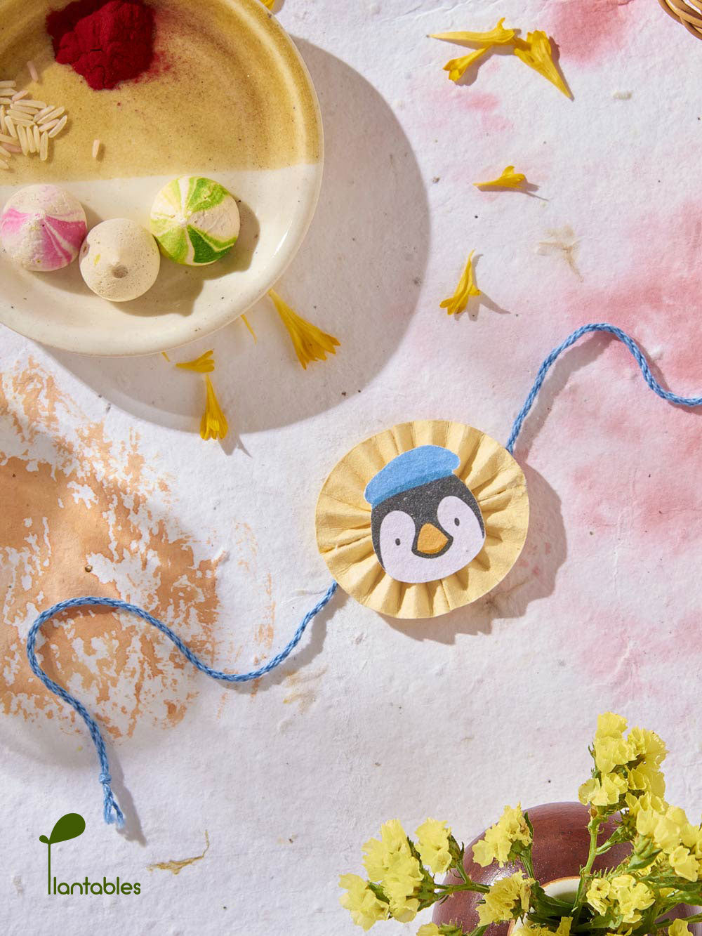 Plantables Penguin with a Blue Beret Rakhi Combo