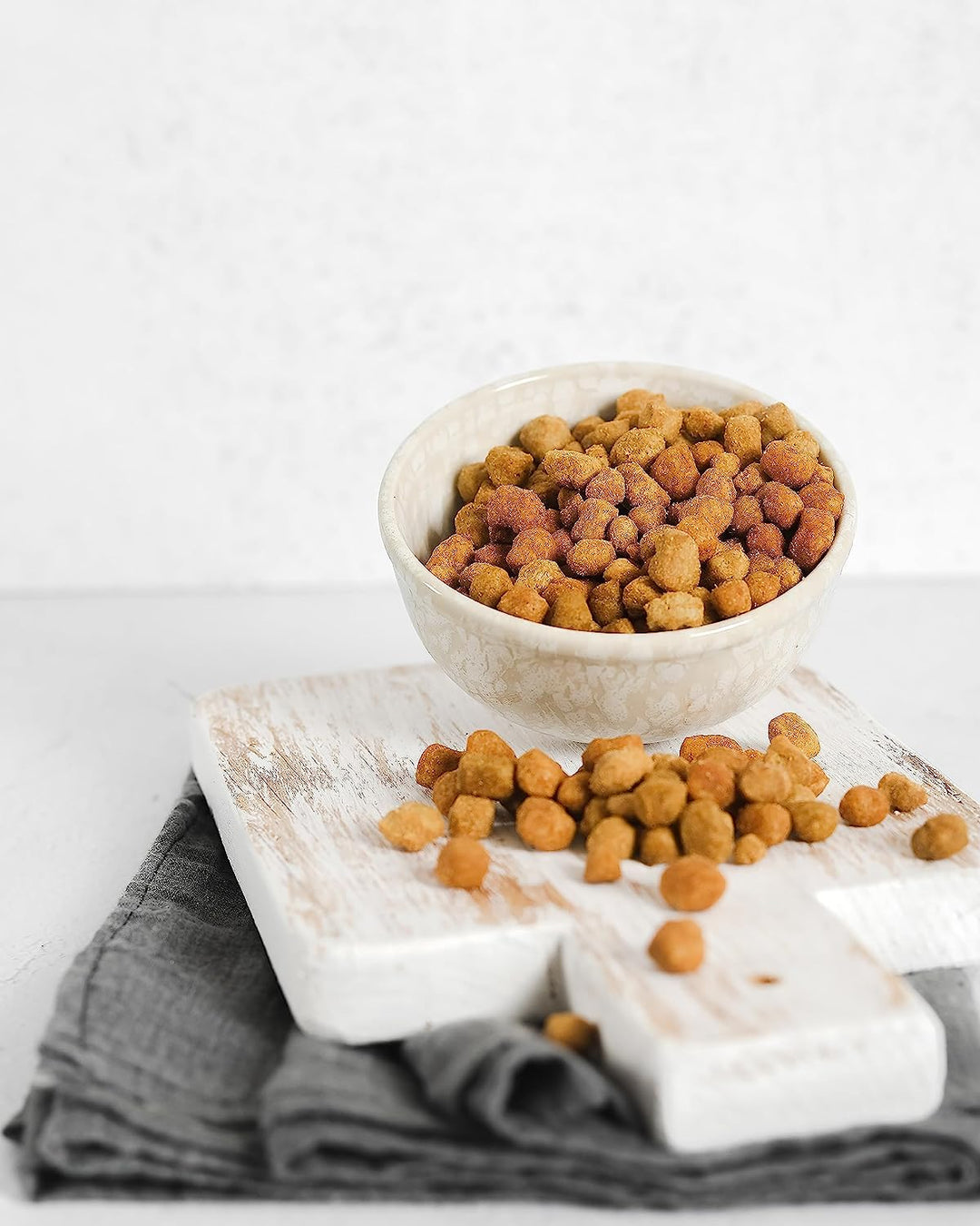 soya chunks served in a steel bowl, all placed on a cozy bed for a relaxed snacking and entertainment experience