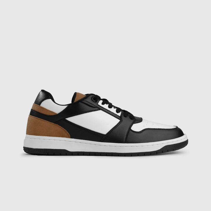 Black, brown, and white sneaker on a light gray background