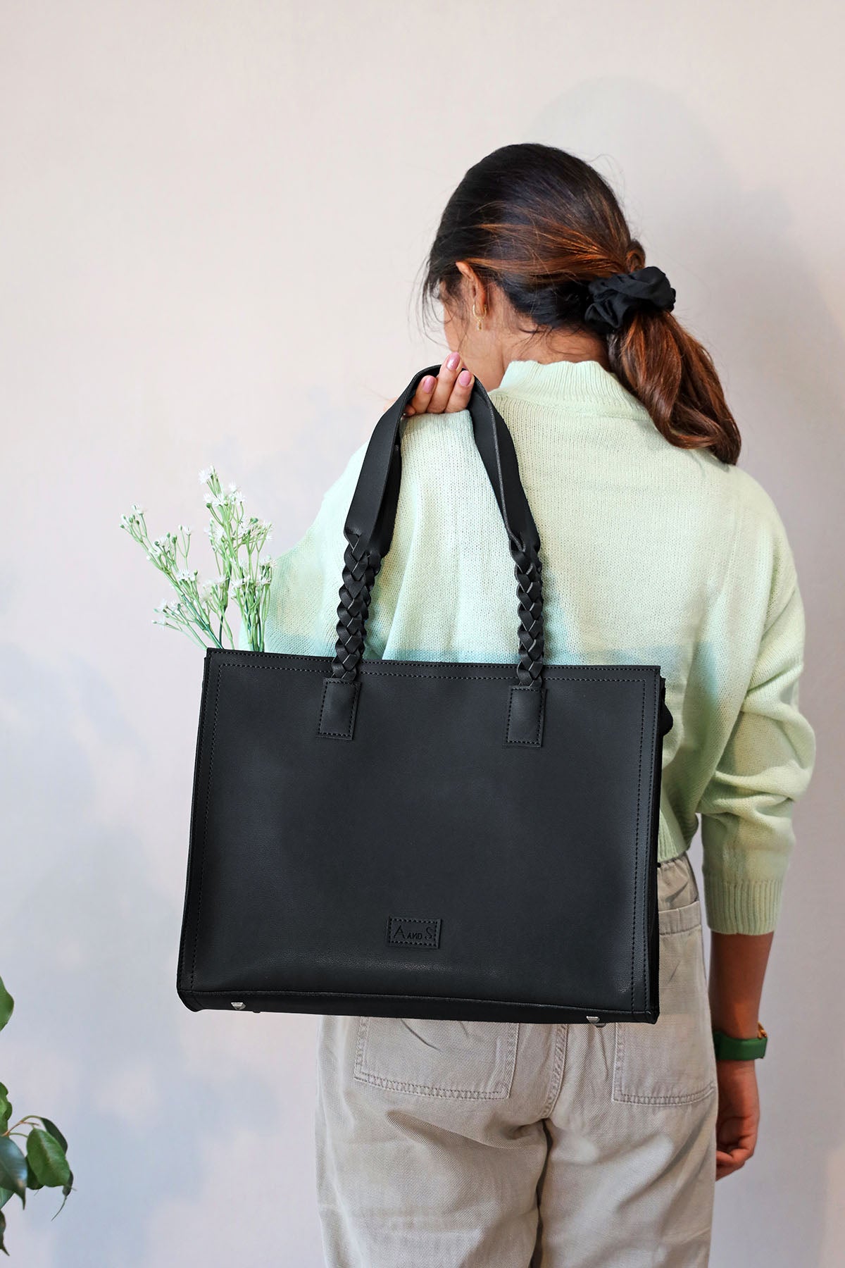 Tote with hand braided handles