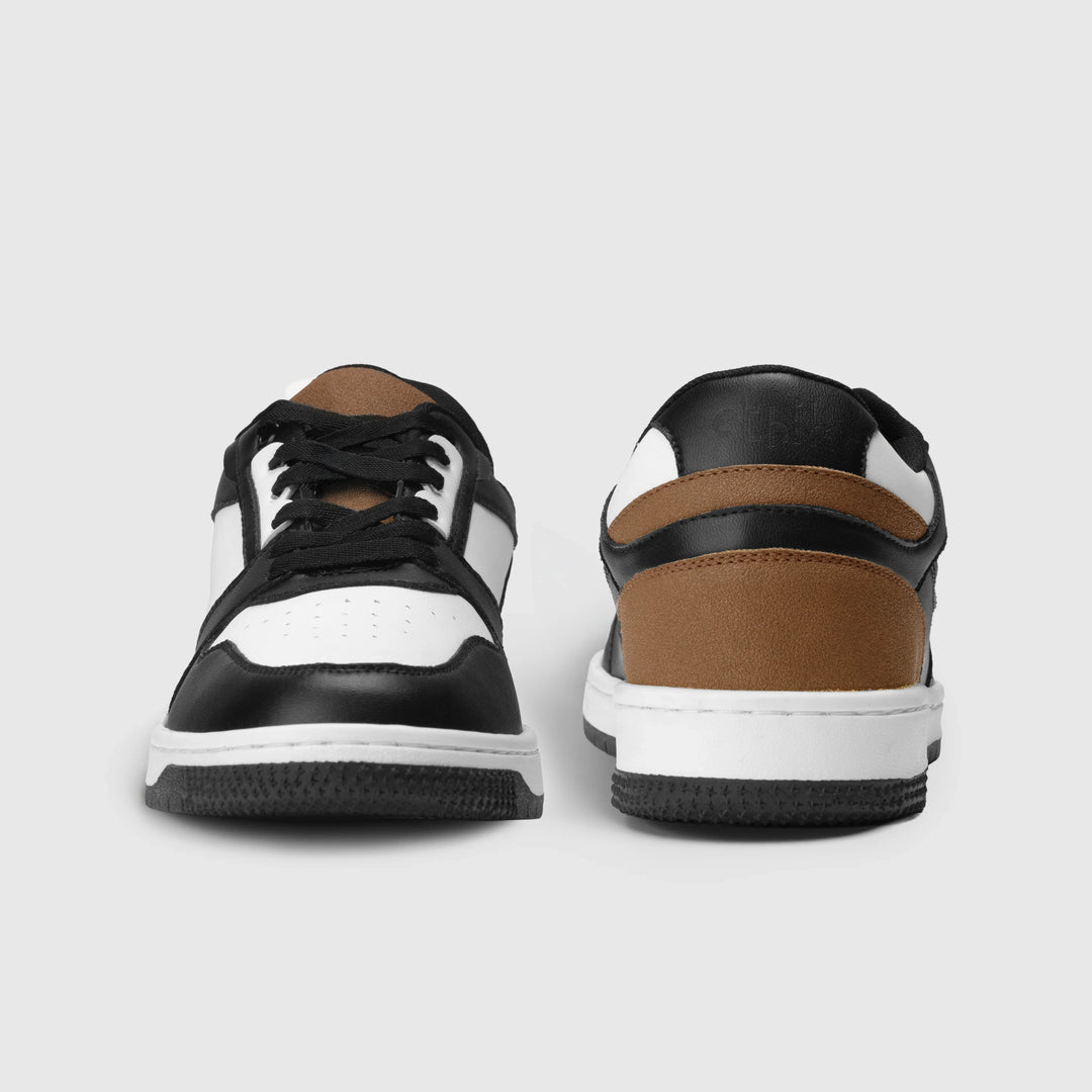 Black, white, and brown sneakers on a light gray background
