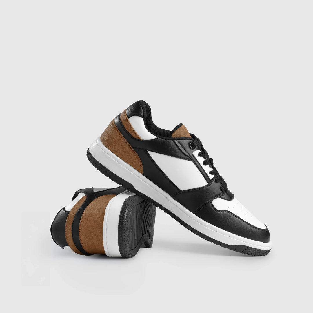 Black, white, and brown sneakers on a light gray background