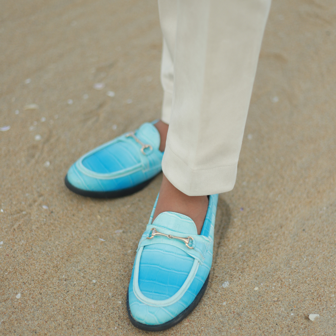 A pair of vibrant Monkstory brand Flatform Horsebit Slip Ons in powder blue crocodile skin, perfect for formal occasions.
