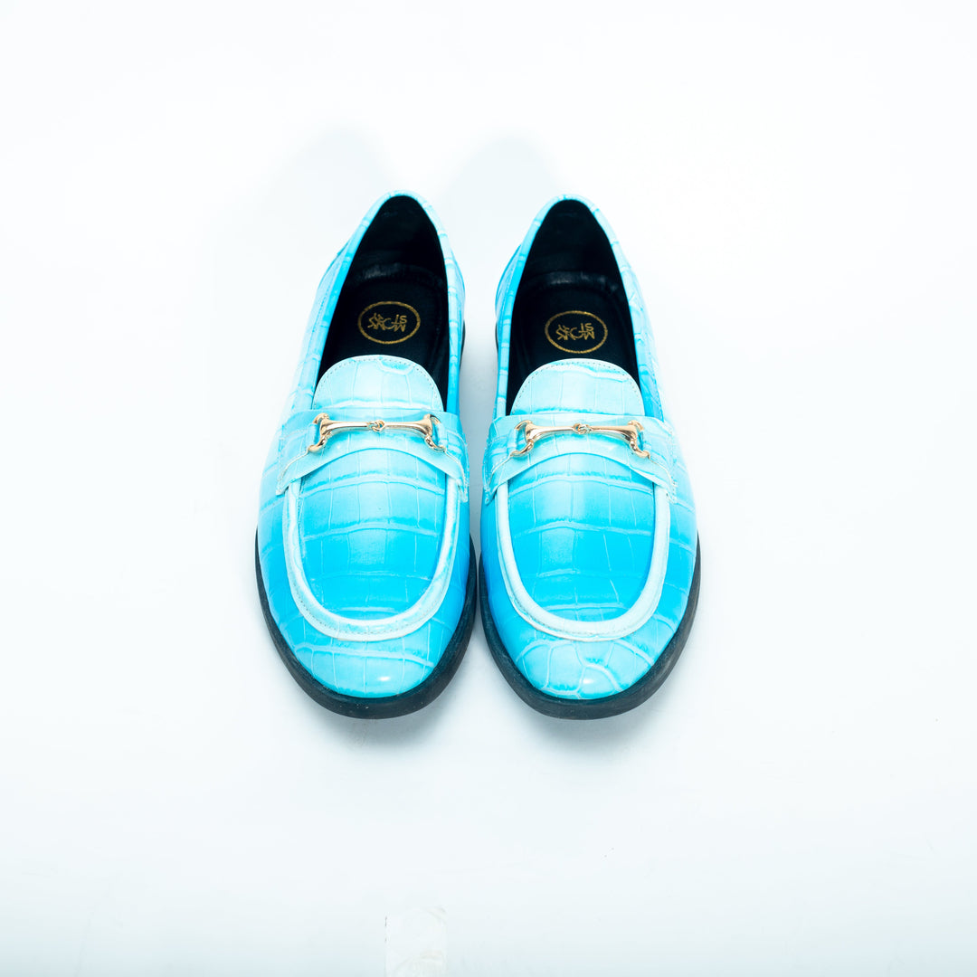 A pair of vibrant Monkstory brand Flatform Horsebit Slip Ons in powder blue crocodile skin, perfect for formal occasions.
